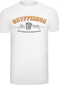 Balta medvilninė marškinėliai, turintys ryškiai raudoną ir auksinę "Gryffindor komandos kvidito" užrašą su herbo dizainu ir dekoratyvinėmis ritėmis po juo.
