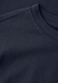 Dark navy t-shirt fabric with a smooth texture. Features a round neckline and visible stitching along the edges and shoulder seams.