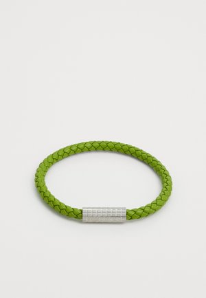 Green braided leather bracelet with a textured silver-tone metal clasp featuring the brand name. Smooth finish with a rounded shape.