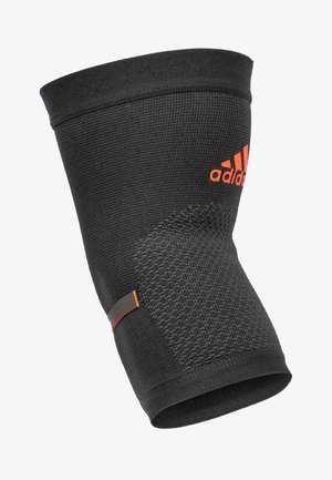 Black Adidas knee sleeve made of textured fabric with a smooth top edge and orange logo detail. Features a non-slip fit design.