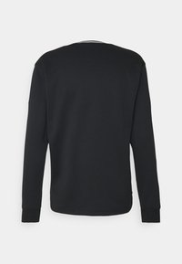 Sweat-shirt noir à manches longues col rond vu de dos avec des poignets côtelés et un ourlet droit.