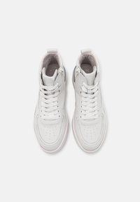 White leather high-top sneakers with textured panels, round toe, perforations, and flat laces; designed with a cushioned collar and zip closure.
