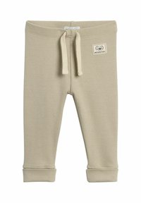 Beige ribbede bukser til småbørn med elastisk talje, snor og opkrøllede sømme. Har et lille stofmærke med en dyreillustration.