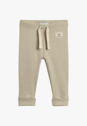Beige ribbede bukser til småbørn med elastisk talje, snor og opkrøllede sømme. Har et lille stofmærke med en dyreillustration.