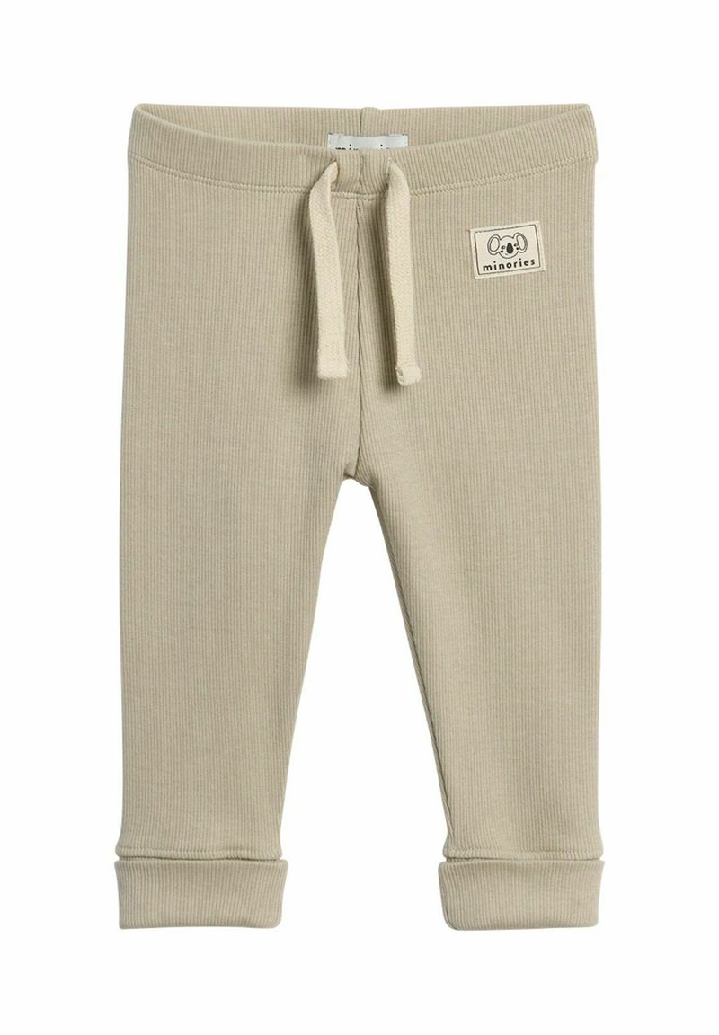 Beige ribbede bukser til småbørn med elastisk talje, snor og opkrøllede sømme. Har et lille stofmærke med en dyreillustration.