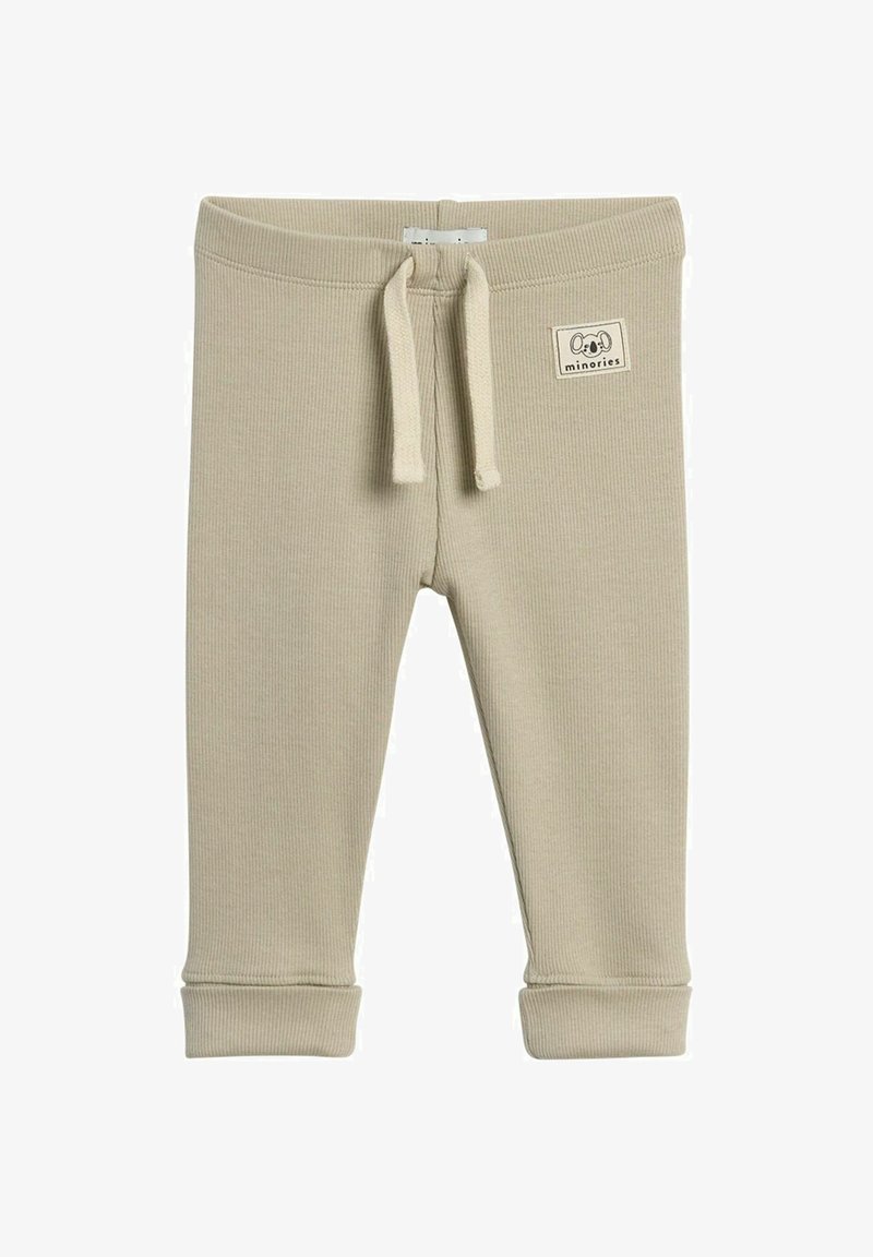 Beige ribbede bukser til småbørn med elastisk talje, snor og opkrøllede sømme. Har et lille stofmærke med en dyreillustration.
