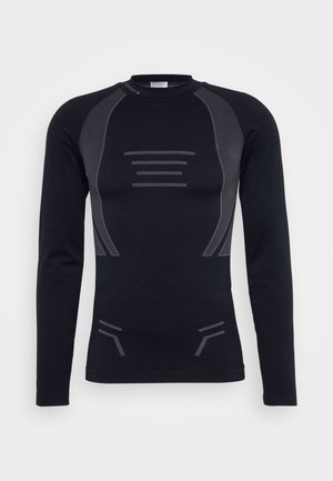 Svart långärmad termotröja med en figurnära design, sömlös konstruktion och kontrasterande mörkgrå texturerade detaljer på axlar och bröst.