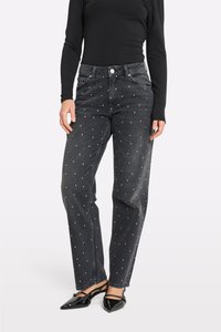 Mustad denim teksad, millel on mugav lõige, ja millel on valgetest kaunistustest koosnev täppmustrit. Tavaline viie taskuga disain.