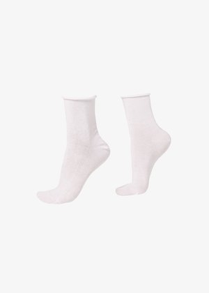 Par de calcetines blancos lisos hasta la mitad de la pantorrilla exhibidos en maniquíes de pie sobre un fondo blanco.