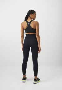 Puma SHAPELUXE SEAMLESS - Leggings - black