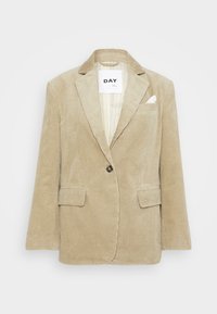 Beige kordfløjsblazer med krave, enkelt knaplukning, to forlommer og en brystlomme. Vandrette ribber i hele stoffet.