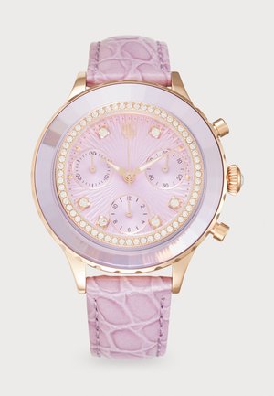 Rund ur med en lilac krokodillederrem, guld-tone kabinet og krystal detaljer. Har en lyserød urskive med tre sub-ur.
