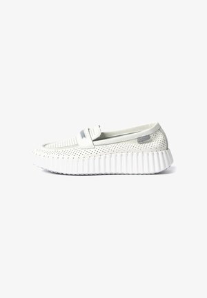 White perforated leather slip-on shoe with thick ribbed sole and a small gray fabric tag near the heel, shown in side profile.