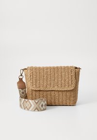 Woven straw crossbody bag with a flap closure, featuring a patterned light brown strap with geometric designs. Textured and compact shape.