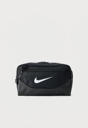 Trousse de toilette noire Nike avec poche zippée frontale et logo swoosh blanc sur fond uni.