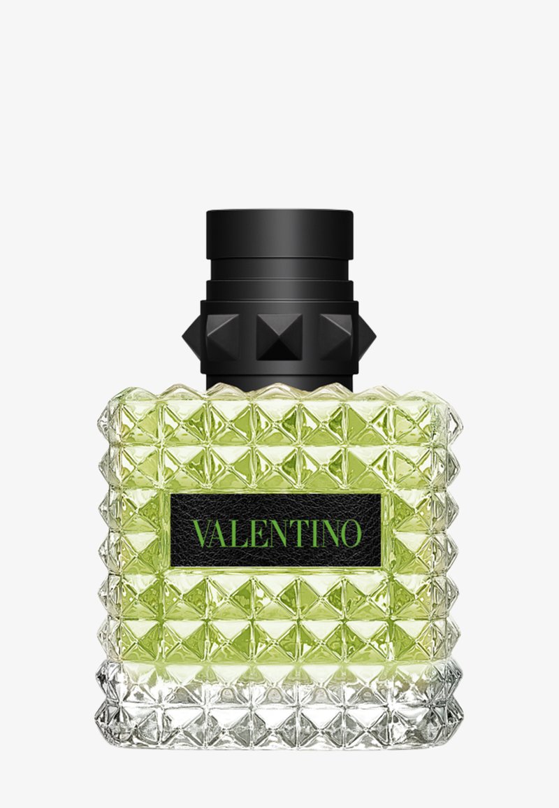 Flacon de parfum carré en verre avec liquide vert, bouchon clouté noir et étiquette noire avec texte vert "Valentino".