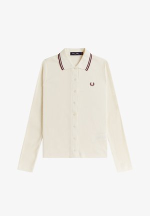 Polo de manga larga en color crema con textura acanalada, botones delanteros, rayas burdeos de contraste en el cuello y logo bordado de corona de laurel en el pecho.