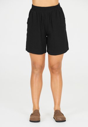 Shorts en lin noir avec une ceinture élastique, des poches latérales et une coupe décontractée. Texture lisse, longueur genoux et sans motifs visibles.