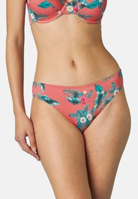 Parte inferiore di bikini color corallo con motivo floreale e accenti turchesi e bianchi. Realizzata in tessuto elastico con una trama liscia.