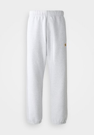 Grey sweatpants with an elastic waistband and cuffs. Soft texture, straight leg design, featuring a small logo on the side.