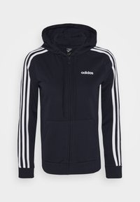 Marinblå zip-up hoodie med vit tre-stripesdesign på ärmarna, tillverkad av ett mjukt tyg, med en framficka och en justerbar dragsko på huven.
