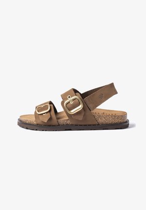Brown sandal with cork footbed, two adjustable gold buckles on straps, and a back strap with a small embossed logo.