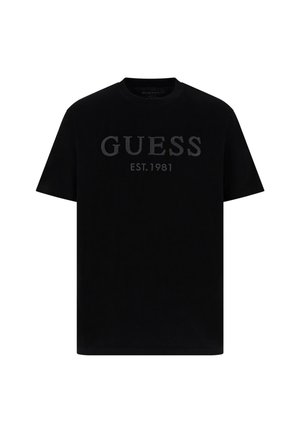 Musta puuvillane T-särk, millel on tõstetud disainiga tekst "GUESS" ja "EST. 1981". Klassikaline ümmargune kaelus ja lühikesed varrukad.