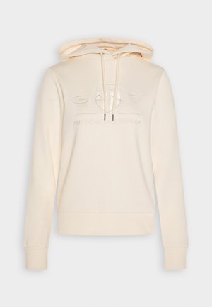 Crème-kleurige hoodie met een ontspannen pasvorm, een trekkoordcapuchon en een reliëflogo op de voorkant. Zacht materiaal en ribgebreide manchetten en onderrand.