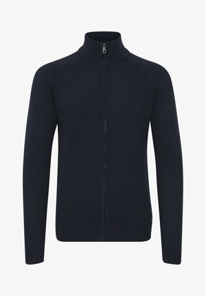 Mornarica dukserica s patentnim zatvaračem sprijeda, visokim ovratnikom, teksturiranim pletenim uzorkom, rebrastim manžetama i rubom te uskim krojem.