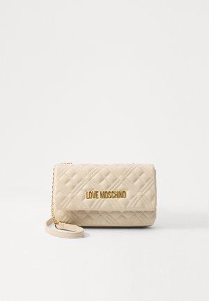 Quilted beige handbag with a gold logo, featuring a flap closure and a detachable chain strap. Smooth texture and rectangular shape.