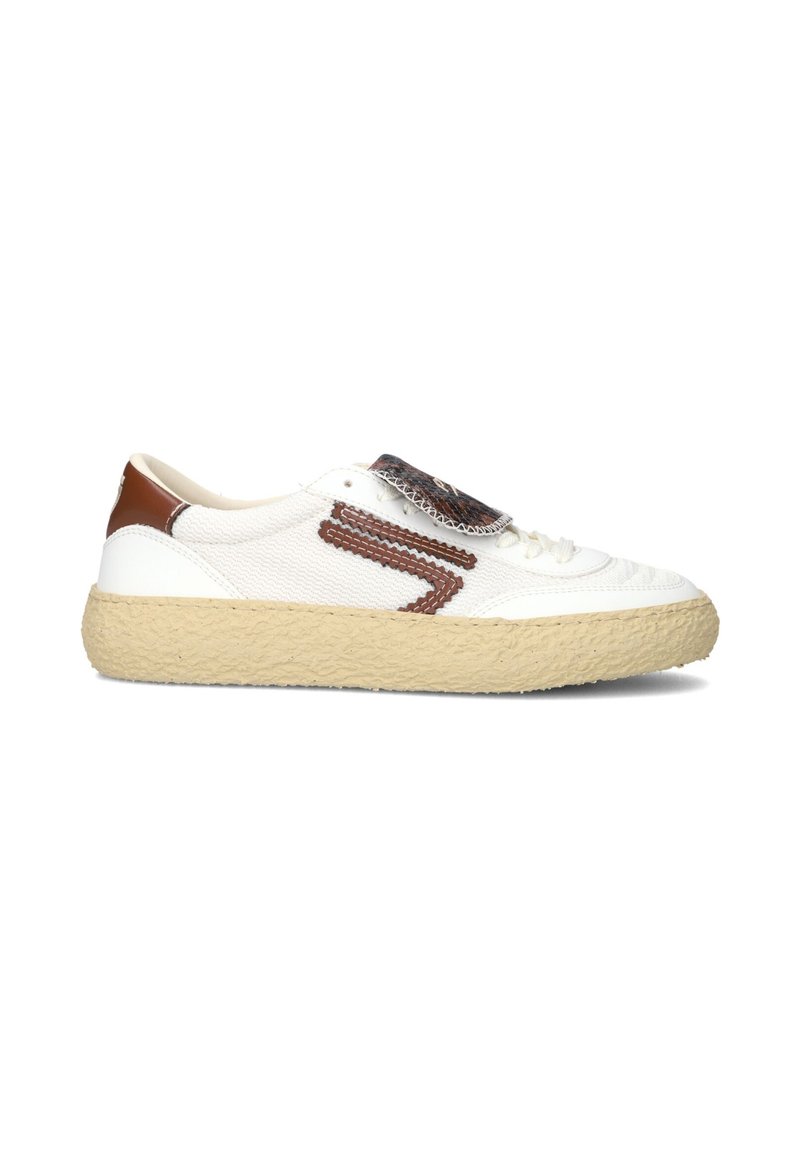 White sneaker with textured fabric upper, brown accents, and a thick beige sole. Features a patterned tongue and side detailing.
