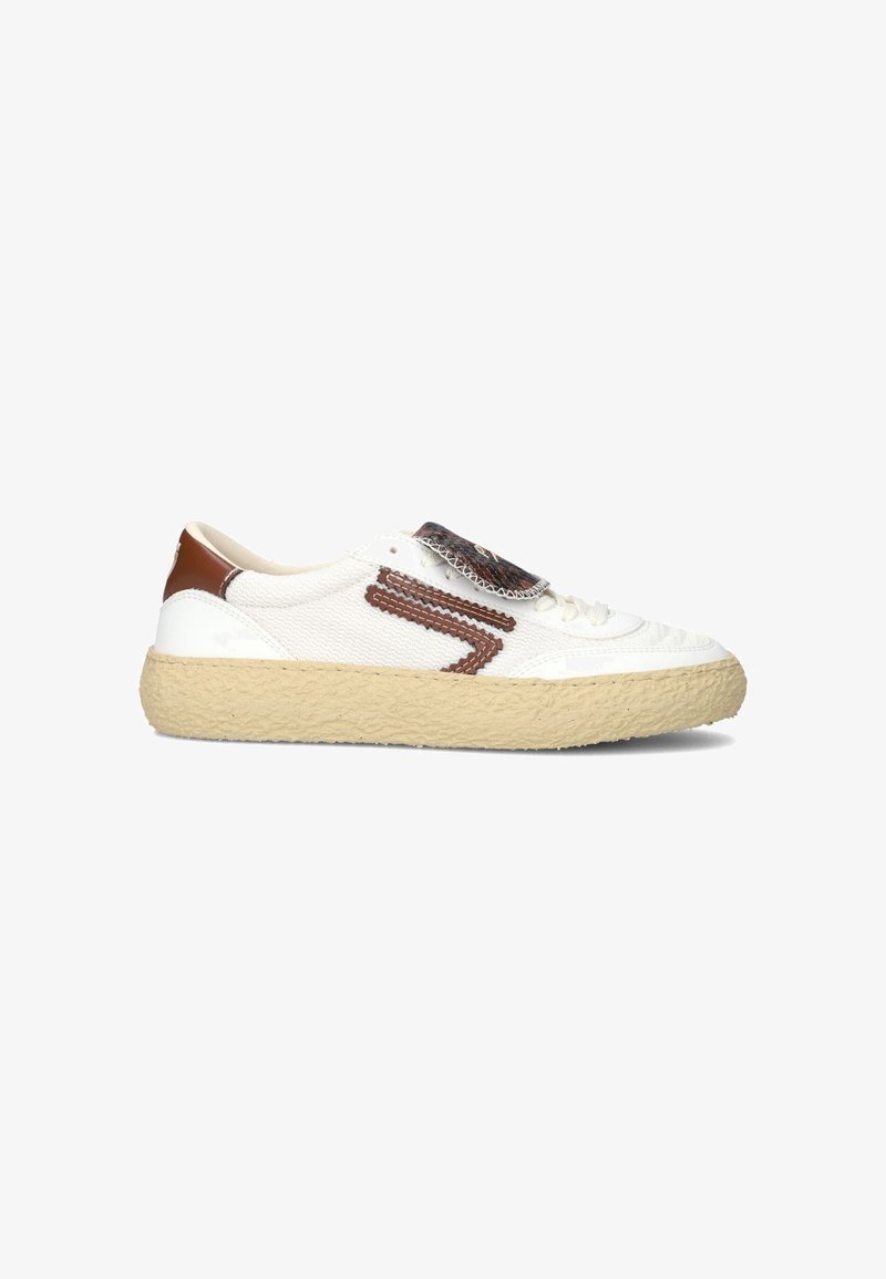 White sneaker with textured fabric upper, brown accents, and a thick beige sole. Features a patterned tongue and side detailing.