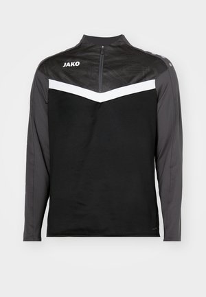 Schwarzes langärmliges Sportoberteil mit zipfbarem Kragen, das einen strukturierten schwarzen oberen Teil, einen weißen Chevron-Streifen und graue Ärmel aufweist.