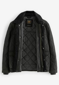Black quilted jacket with a corduroy collar, zip and snap closures, and a textured gray lining. Features side pockets and regular fit.