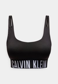 Μαύρο αθλητικό σουτιέν Calvin Klein με φαρδιές τιράντες και ελαστική ζώνη με το λογότυπο κάτω από το στήθος σε λευκό φόντο.