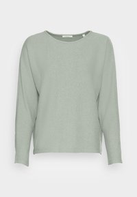 Långärmad topp i ljusgrönt, tillverkad av texturerat tyg med lös passform. Har rund halsringning och rak fåll. Minimalistisk design.