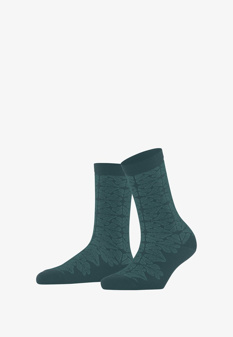 Ciemnozielone skarpetki za kostkę z subtelnym liściastym wzorem wplecionym w materiał, przedstawione stojące obok siebie.