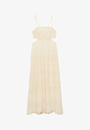 Krémové maxivské šaty s tenkými ramienkami, ktoré majú výrezy a vyšívané vzory očiek pozdĺž lemovania a korzetu.