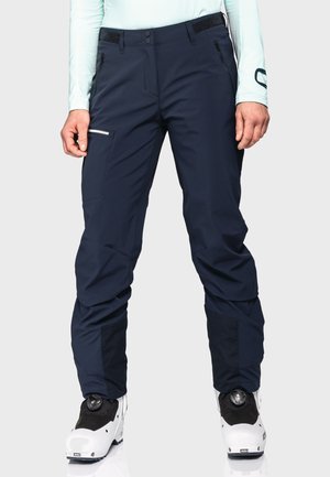 Dark navy ski pants with a sleek design, made from a durable material. Features include zippered pockets and a reinforced lower leg.