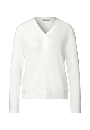 Vit långärmad topp med V-ringning och en knappdetalj vid kragen. Mjuk tyg, figurnära design med en åtsittande midja.