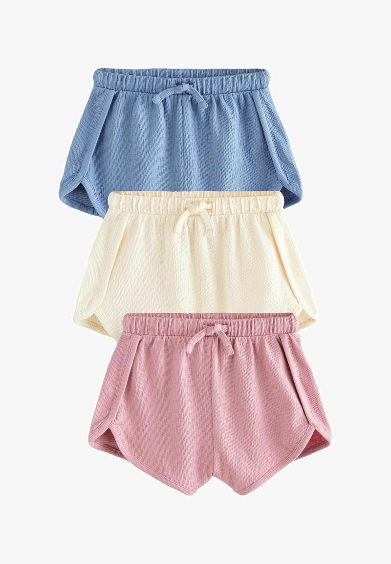 Three textured fabric shorts in blue, cream, and pink, each with elastic waistbands and front drawstring ties.
