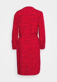 Robe florale rouge avec des manches longues, une taille ceinturée et une coupe au genou. Dotée d'un tissu texturé avec de petits motifs floraux sombres.