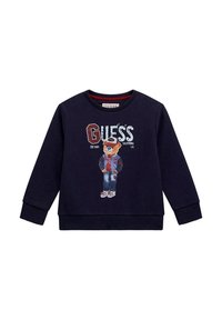 Felpa blu navy in cotone con scollo rotondo, dotata di una grafica di un orso in giacca e del logo "GUESS" stampato in evidenza.