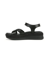 Black leather platform sandals with crisscross straps, a cushioned footbed, and a woven-texture sole. Adjustable ankle strap for fit.