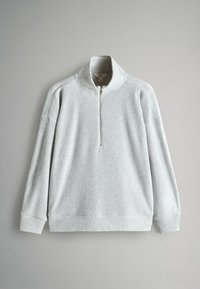 Heledad hallhall ribategija, quarter-zip kraega, pikkade varrukatega ja tekstuurse kangaga. Omab lõdva lõikega ja minimaalset disaini.