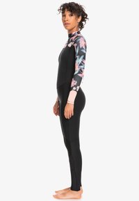 Black wetsuit with colorful floral pattern on sleeves, high neck design, smooth texture, and flat seams for comfort.