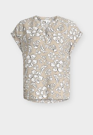 Blouse beige à manches courtes avec motif floral blanc et noir, encolure ronde avec patte de boutonnage partielle, et coupe décontractée.
