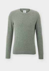 Ljusgrön tröja i mjukt, strukturerat material. Har en rundad halsringning och ribbade muddarna och fållen. Lätt figursydd design.