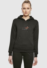 Black hoodie made of cotton blend, featuring a front pocket and drawstrings. It has a printed candy cane graphic and text on the chest.