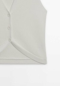 Top senza maniche in maglina a coste grigio chiaro con scollatura a V, caratterizzato da una chiusura frontale con bottoni e un orlo leggermente curvato.